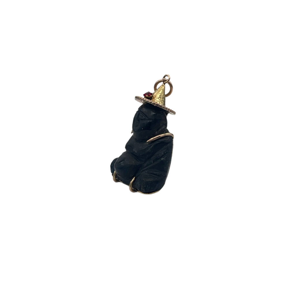 Very Rare Carved Black Sapphire (corundum) Buddha charm/pendant encased in 14k yellow/rose gold, with little decorative red glass stone on hat. Unique piece, chatoyance clearly visible on the face of the Buddha. Beyond the symbolism, this pendant is distinguished by its rarity.